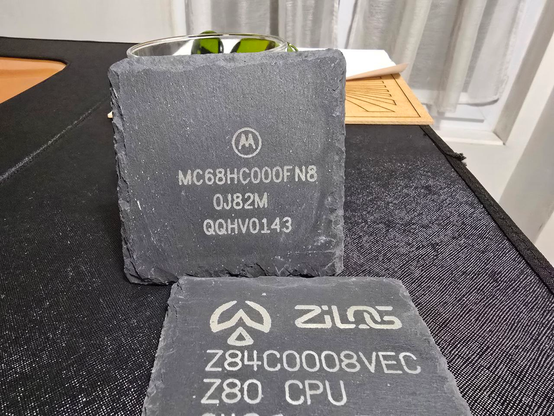 Laser engraved slate coasters showing markings of a z80 and a 68k.