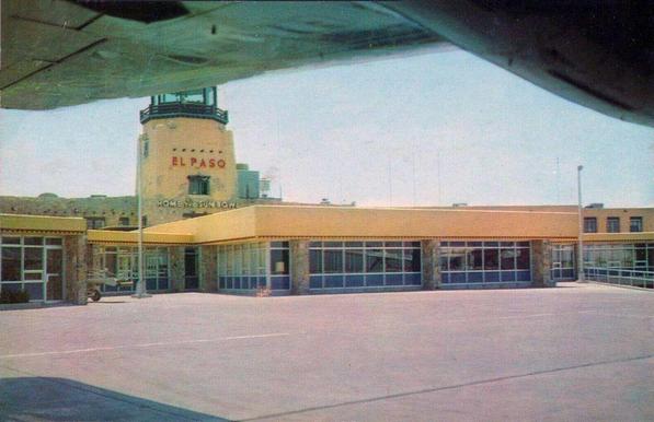 You see the terminal and the tower from under a prop plane wing.