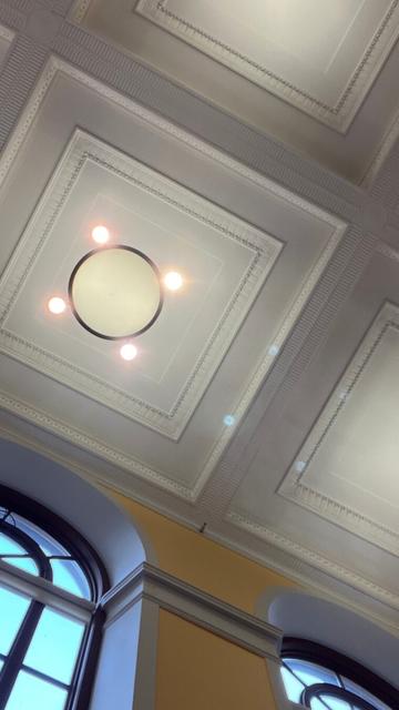 the why? prairie ceiling, light fixtures and portion of arched windows emphasizing the angles of trim and light