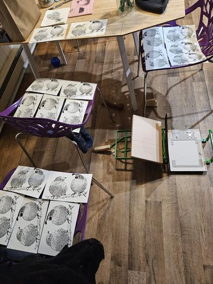 several chairs with 5 prints each laid out on them, plus a few more on the table. they're all prints of the detail layer of the quails with no brown color layer