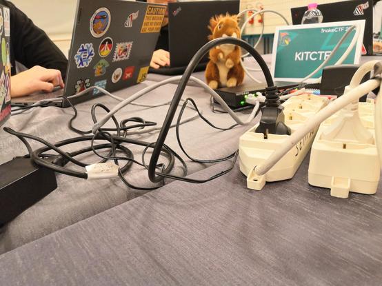 Flag-squirrel in the game arena at the KITCTF table.