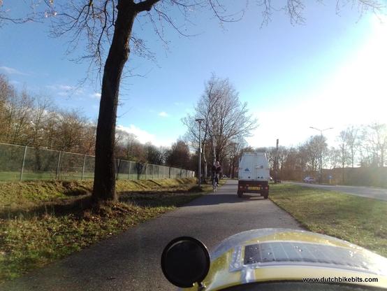 Maintenance vehicle on a cycle-path in front of my velomobile on the cycle-path There is nominally room to pass, but there's a cyclist coming in the opposite direction.