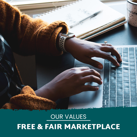 Stock image of two hands typing on a computer keyboard with the words, "Our Values. Free & Fair Marketplace"