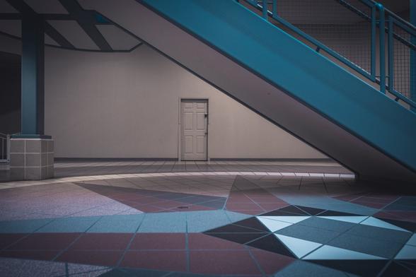 Photo of an access door framed under a set of stairs