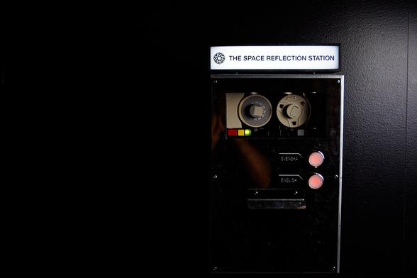 Part of the exhibition is a photo station where AI is used to analyze your face, predict your age, and give you some questions to reflect on. This picture shows the device, a silver colored box on the wall.