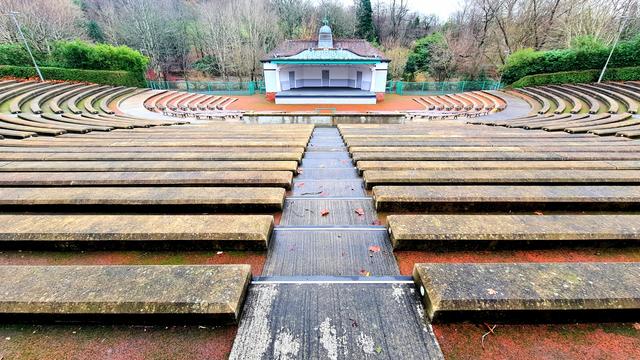 A rectangular 1920s bandstand set in the middle of an amphitheatre built into the bank of the River Kelvin in Glasgow.