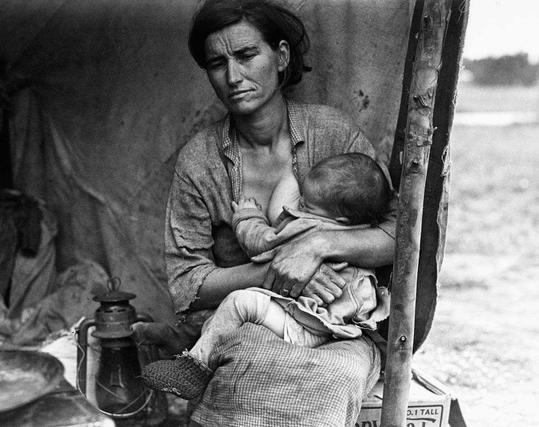 This black and white photograph depicts a woman sitting on what appears to be the back of a truck, with her left arm supporting herself while she cradles an infant in her right arms. She is wearing a sleeveless blouse that exposes part of her shoulder and chest, along with a skirt or apron-like garment around her waist. Her expression is pained or distressed as she gazes off to the side.
In front of her on the truck's seat are various objects including what looks like an oil can, some papers, and possibly other personal belongings. The background shows a blurry rural landscape that suggests movement due to camera shake typical in historical photographs taken with handheld cameras without stabilization systems such as tripods or shutters.

This image is associated with Dorothea Lange's famous series of work during the Great Depression in America. It captures the harsh realities faced by many families who were displaced and impoverished at this time, often referred to colloquially as 'Okies' due to their mass migration from Oklahoma.
The photo carries historical significance as it represents not only a personal moment but also reflects on societal issues such as poverty, displacement, and resilience during one of America's darkest periods. It is widely regarded for its emotional impact and has been used in various media including books, magazines, art exhibits, television documentaries, films like 'Ozark,' and even video g [...]