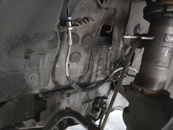 A Ln image of a stainless steel brake line installed on a vehicle.