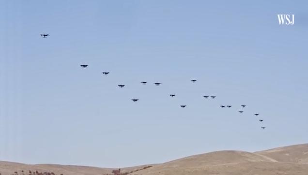 A photo in daylight of a swarm of about 30 drones in the US prairies, illustrating co-ordinated drone take-off. 

source https://m.youtube.com/watch?v=xb5qMvie9sU