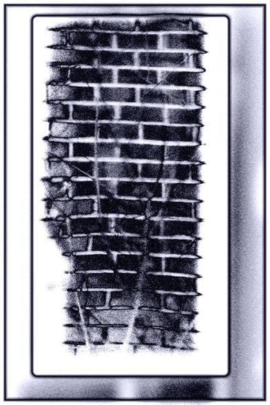 Solarized photo of a reflection of a wall seen through a window in a mirror.