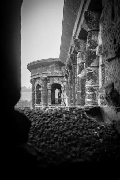 a photograph of the upper part of the fascade of Porta Nigra through a window