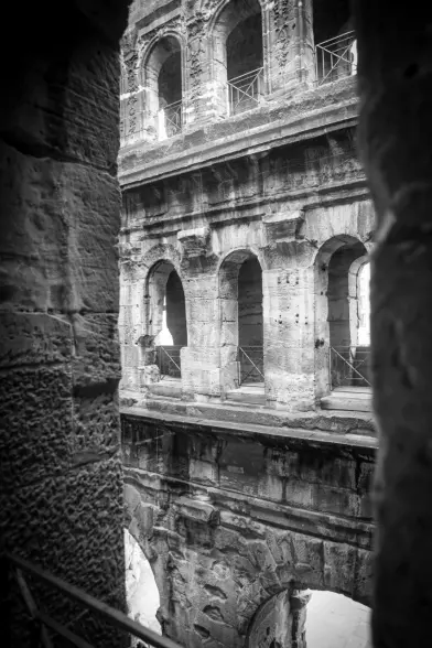 a photograph of the inner part of Porta Nigra. On the lower part the arch ways, above them the windows of the other floors
