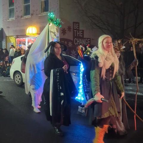 Mari Lwyd walking down the street with some of the other characters.