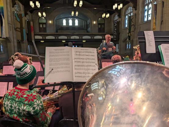 The bell of my euphonium with other euphonium and tuba players warming up in the chapel.