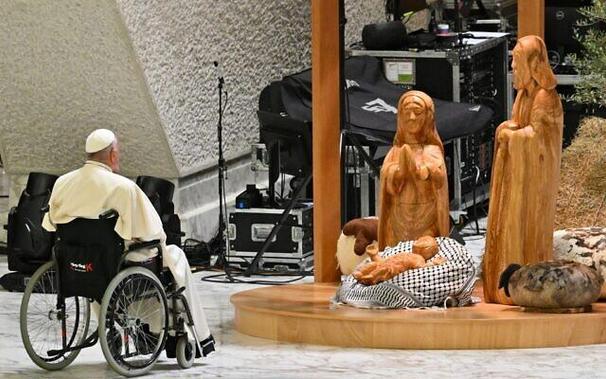 Pope at 2024 nativity scene with baby Jesus wrapped in Palestinian keffiyeh