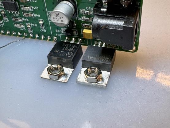The two through hole voltage regulators. There are screw nuts on the thermal pads that have a dab of solder in the corner keeping them in place. The components are already soldered into the RF PCB.