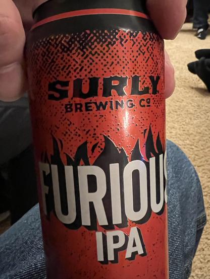 A red can of Surly Furious IPA beer. The brand lettering is black, the word FURIOUS and IPA are in white