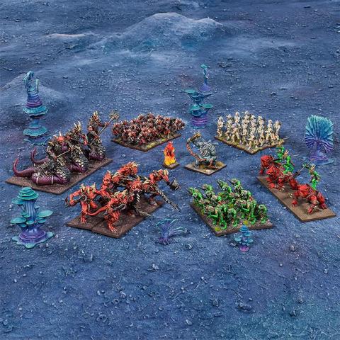 A variety of colorful miniatures from the Kings of War starter set are displayed on a blue textured surface, representing the Trident Realms and Forces of the Abyss factions.