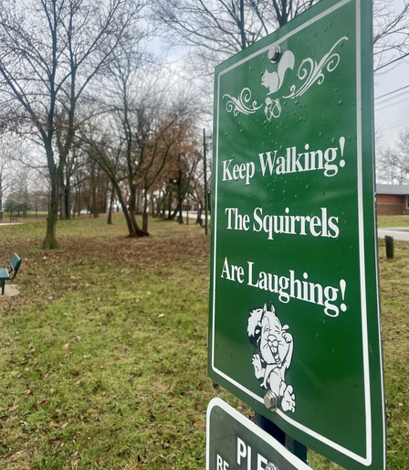 A sign alongside the walking trail at Olney City Park.