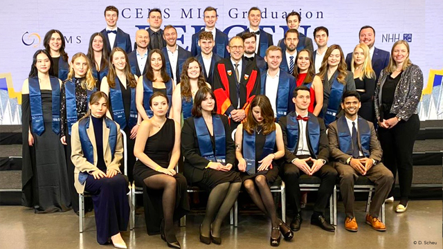 A group of festively dressed CEMS MIM graduates from the University of Cologne surrounds WiSo Dean Ulrich Thonemann for a group photo at the CEMS MIM Graduation 2024 in Bergen.