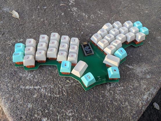 "cinereus-zayin" ergo-mechanical keyboard PCB with C3Equalz Tangerine switches and MT3 Jukebox keycaps all controlled by a small Elite-C microcontroller board