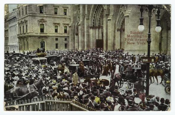 This postcard depicts a bustling city scene from what appears to be late 19th or early 20th-century New York City. The main focus is on Fifth Avenue during Sunday morning with crowds of people gathered outside St. Patrick's Cathedral, identifiable by its distinctive Gothic architecture and the large arches above the entrance.

The street is filled with numerous horse-drawn carriages carrying passengers through the dense crowd. Individuals are dressed in period-appropriate attire: men wearing hats, coats, and trousers; women adorned in dresses and hats of various styles reflecting the fashion norms of that era. Many people carry umbrellas or parasols, suggesting it may be a rainy day.

The atmosphere seems lively yet orderly despite the apparent congestion. The postcard is marked with text at its top right corner reading "Sunday Morning in Fifth Avenue New York," indicating both the time and location captured within this image. Additionally, there's an ornate street lamp to the upper left of the cathedral adding to the vintage aesthetic.

This snapshot captures a typical day in early urban life in America during that period, showcasing social interactions, fashion trends, modes of transportation, and architectural styles prevalent at the time.