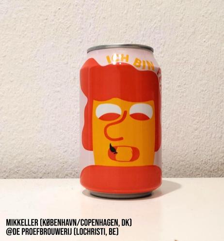 A 330 ml can with a simple, cartoonish drawing of a face in bright orange, white, and dark orange