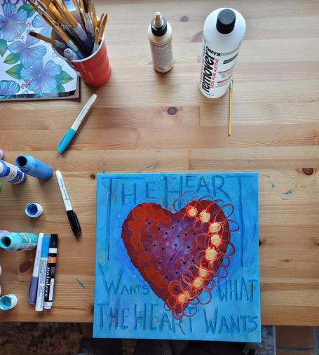 Colorful heart painting with the words The Heart Wants What The Heart Wants by artist Sharon Cummings.