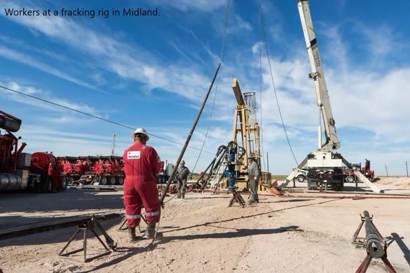photo - workers at a fracking rig in Midland, TX