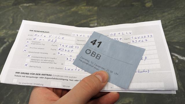 A waiting ticket and a filled form with ÖBB logo.