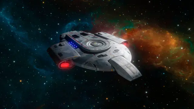USS Defiant from Deep Space Nine in space, a colorful blue-orange-green nebula in the backgroud.