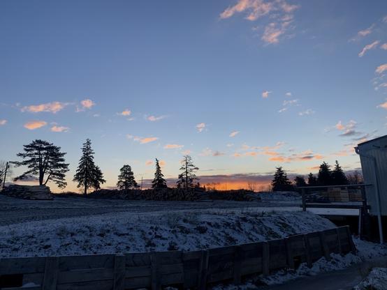 The morning sunrise. The sky has some deep blues still. The sun has a bit of an orange and pink colour