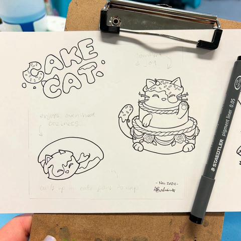Lineart drawings in ink, of “cake cats.” One cat made of cake, curled up. One cake with cat qualities.