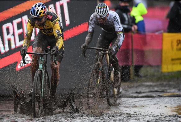 Wout van Aert and Mathieu van der Poel race cyclo-cross is very wet and muddy conditions.