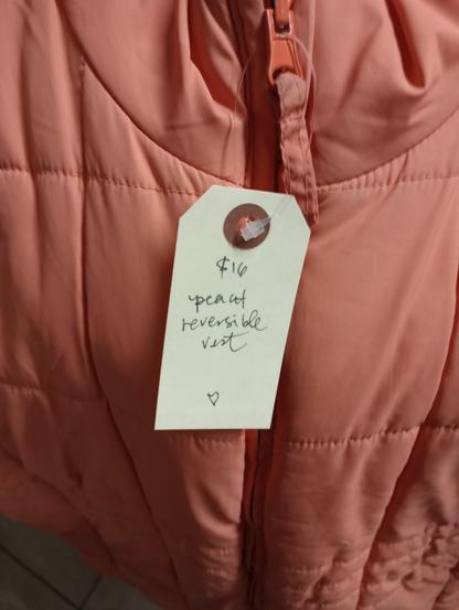 the tag on a peach vest that reads $16 peach reversible vest