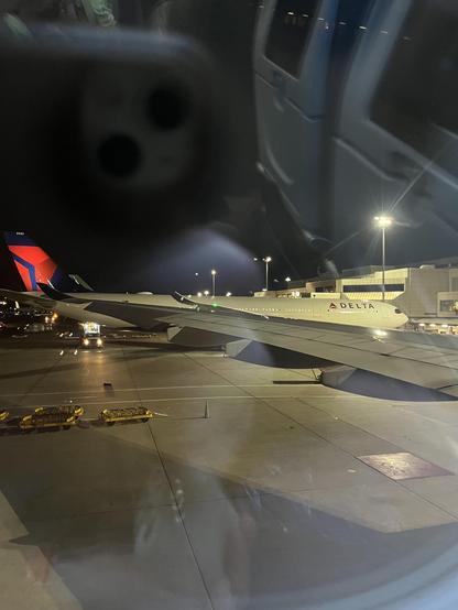 Wing of plane in front on Terminal E at Logan Airport