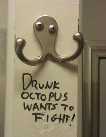 a coat hanger with a sing underneath, "drunk octopus wants to fight"