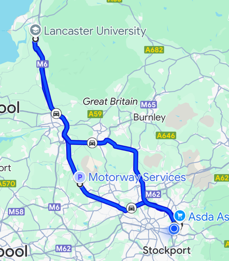 A map showing a route from Lancaster University to Asda in Ashton-under-Lyne, England. The route is highlighted with a blue line and includes several major roads, including the M6, M61, M65, M60 and M62 motorways. There are several other landmarks and towns visible on the map, such as Burnley, Stockport, and Liverpool.
Overall, the image provides a clear visual representation of the route from Lancaster University to Ashton.
