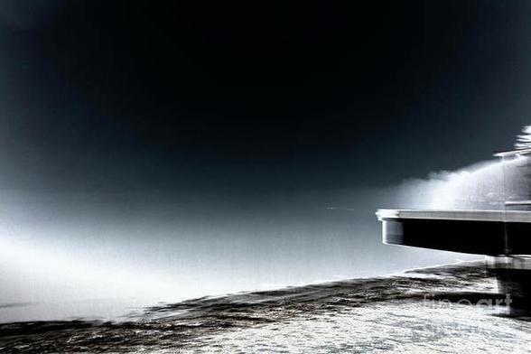 Solarized color photography abstract of snow falling at the lake in dense fog