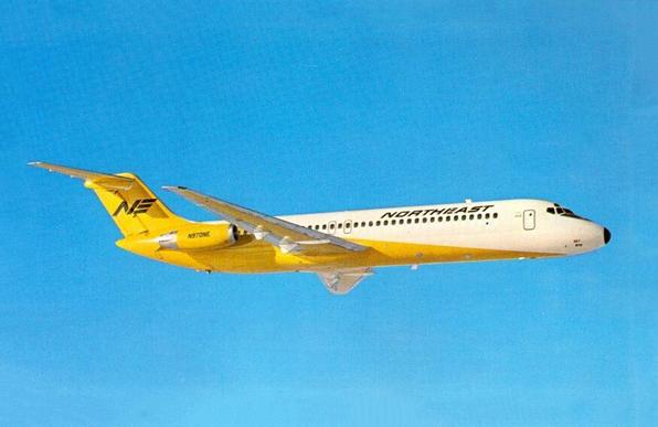 DC-9 flying left to right. It has its Yellow tail livery.