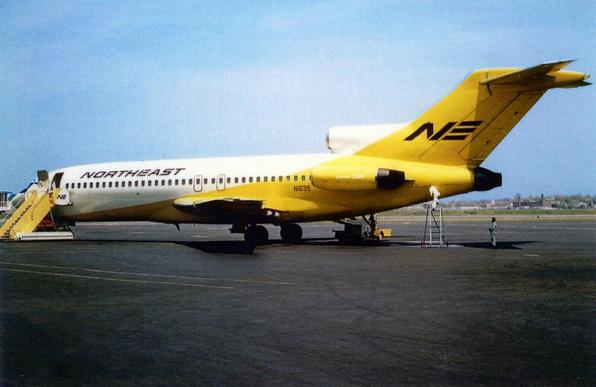727 parked at the stand with a set of air stairs. This is the short 100 series. It has its Yellow tail livery