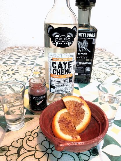 mezcal tasting with a bottle of Cayechenu joven made of tobala agave and of Montelobo joven made of espadín.