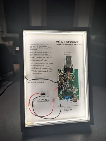 A framed circuit in the style of these disassembled iPhone frames. The frame is a black wooden picture frame with a white LED strip all around. The frame contains an old circuit board found at cccda. The board is a preexisting pcb design for something else, that happens to have two VGA ports. Someone then desoldered some of the SMT compontens and built a second layer of resistors, capacitors and transistors on top to convert the circuit to something that fixes a VGA signal. Looks really hacky.