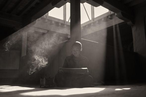 Novice monk reading prayers in Nepal