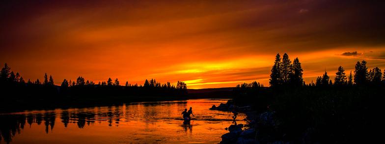 Close to the headwaters of the Snake River in Grand Teton National Park, a dozen miles from Yellowstone, a group of children takes a sunset swim.