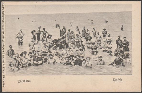 Printed monochrome postcard showing a large group of bathers at Siófok on Lake Balaton in Hungary.
Published by Ellinger Ede, Budapest, not numbered, undivided back, c.1905.
Postally unused.
Very good condition, with very slight corner bumps.