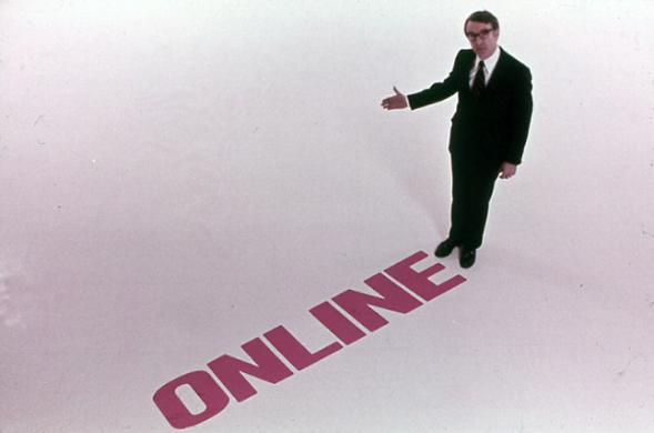 a man in a black suit stands next to the word ONLINE on a white background