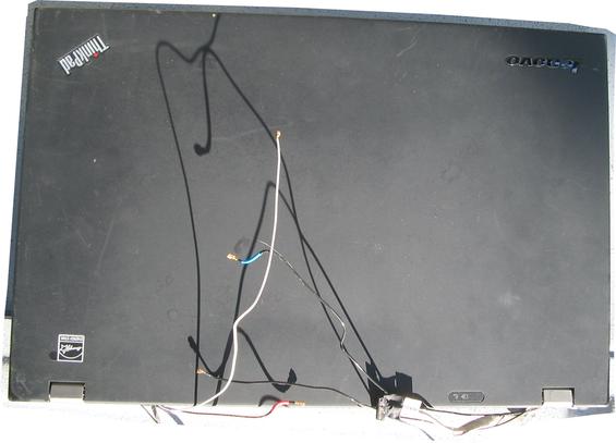 A ThinkPad T530 lid removed from the body of the laptop, being offered