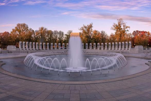 Panoramic view of the World War II Memorial in Washington DC at sunset, capturing the tranquil atmosphere and historic significance.