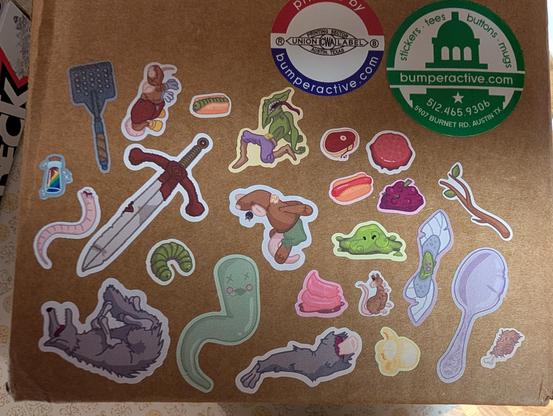 Stickers on a box representing items from the game, Dunderbeck.